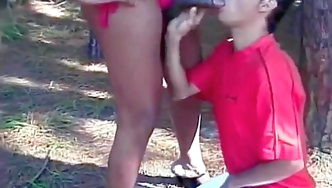 Ebony milf deep throats her friend's big dick outdoors